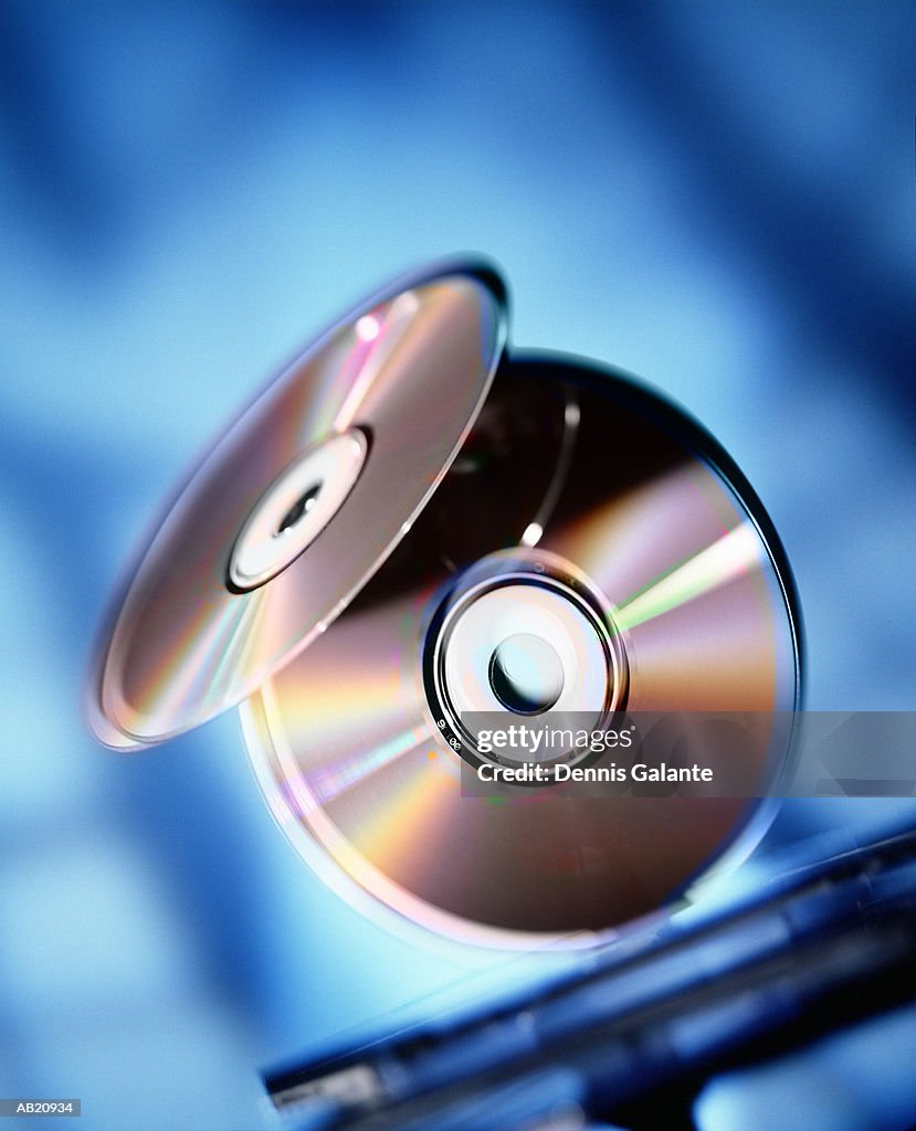 Compact discs balancing on edge (digital composite)