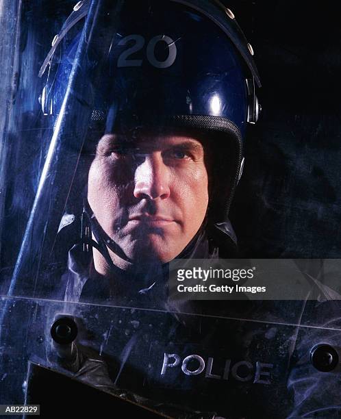 close-up of riot policeman - police in riot gear stock-fotos und bilder