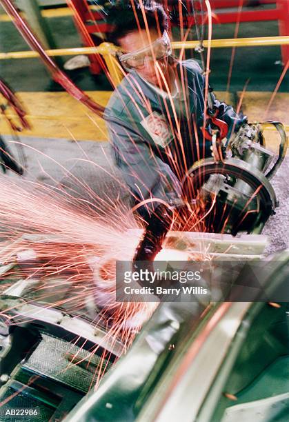 production line worker spot welding car panels, elevated view - willis stock-fotos und bilder