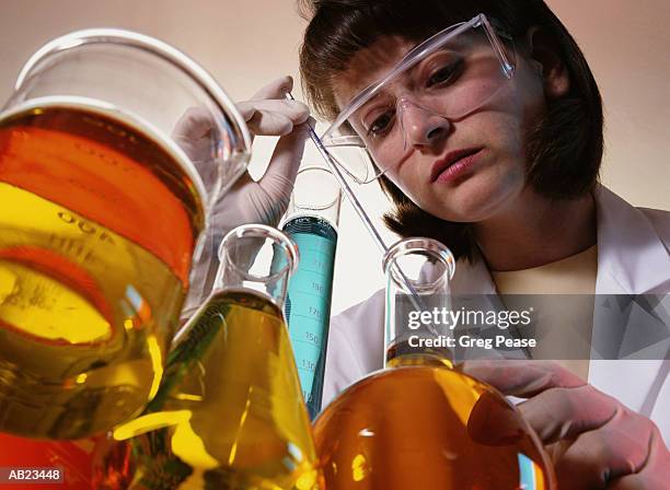 female researcher using pipette, close-up, low angle view - greg pease stock pictures, royalty-free photos & images