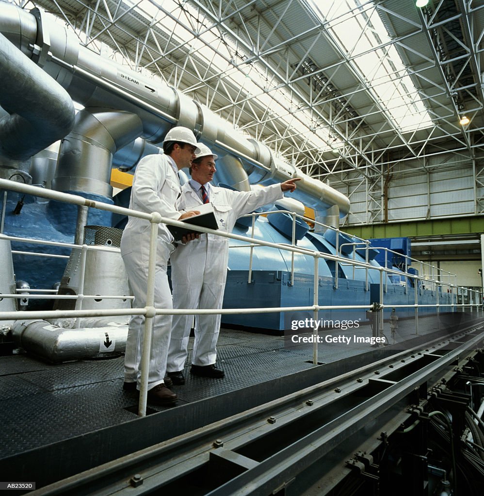 Two men wearing protective gear in meeting at nuclear power plant