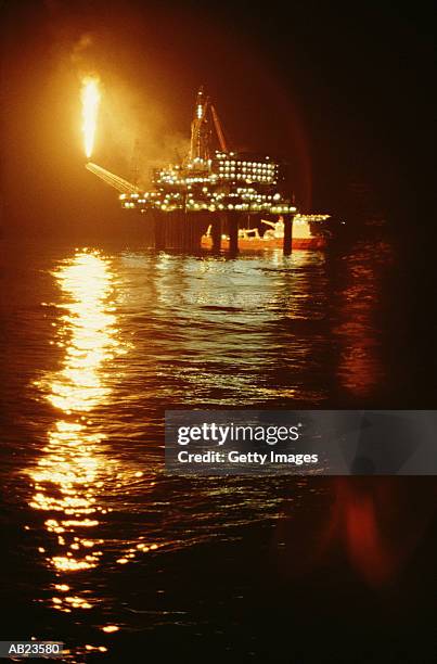 oil rig in ocean at night - flare stack stock pictures, royalty-free photos & images