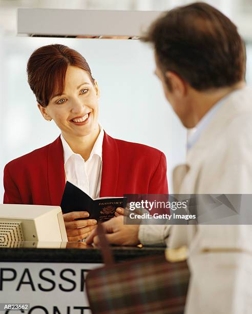 man checking in at passport control - stansted airport stock pictures, royalty-free photos & images