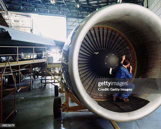 engineer checking intake blades of airplane - aeroplane engineer stock pictures, royalty-free photos & images