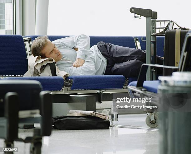 passenger asleep at airport gate - eastern england 個照片及圖片檔