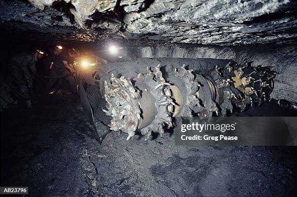 miners operating drill in coal pit mine - pit mine foto e immagini stock