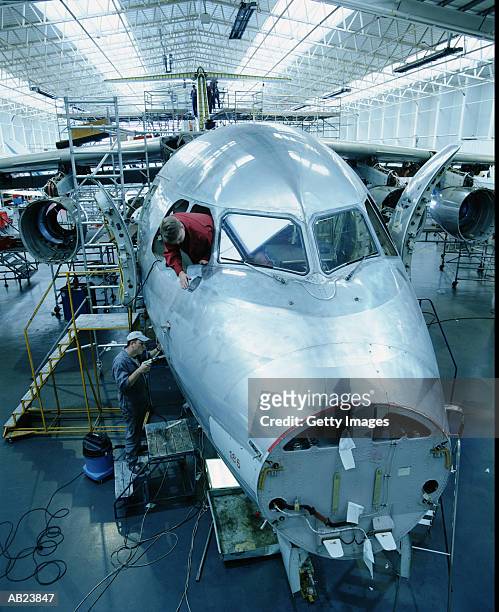 workers building airplane in hanger - getty images uk stock pictures, royalty-free photos & images