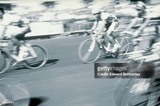 cyclists racing on street in tour de france / paris, france - tour de france black and white stock pictures, royalty-free photos & images