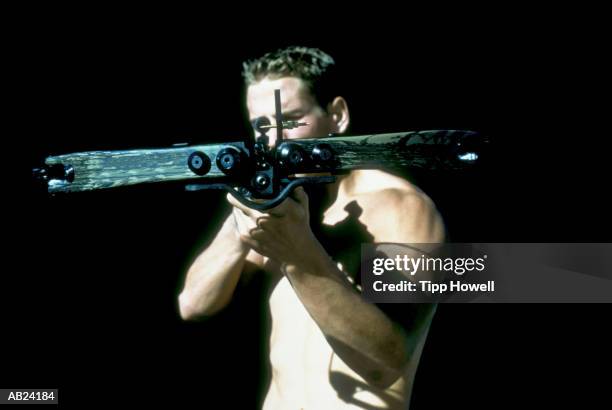 male archer aiming crossbow, close up, portrait - crossbow stock pictures, royalty-free photos & images