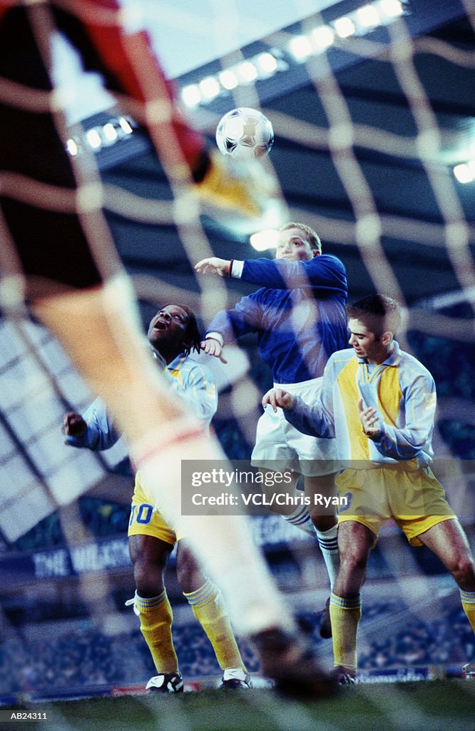 Soccer player hitting ball with his head