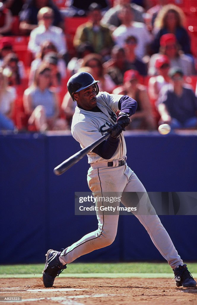 Baseball player swinging at ball
