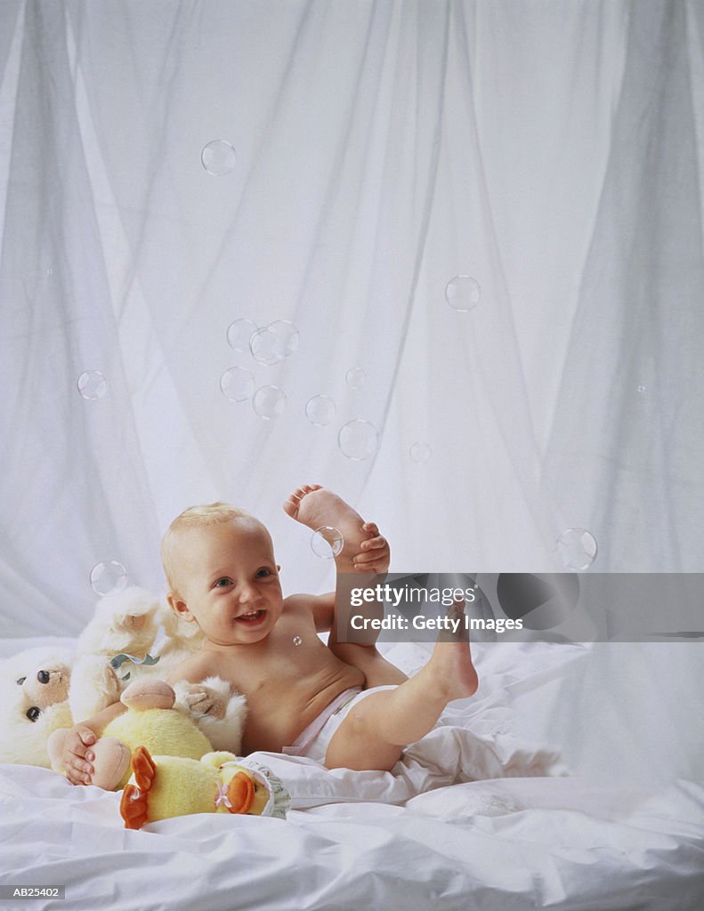 BABY WITH BUBBLES AND TOYS