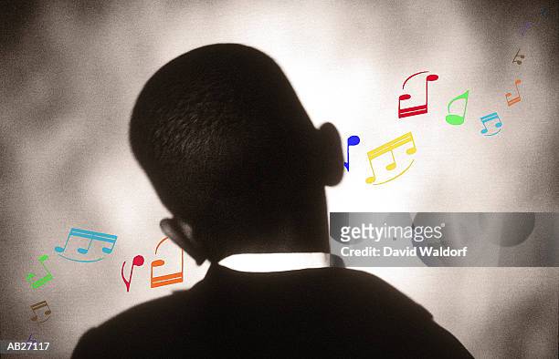 boy (8-10) with musical notes coming from ears, rear view - waldorf fotografías e imágenes de stock