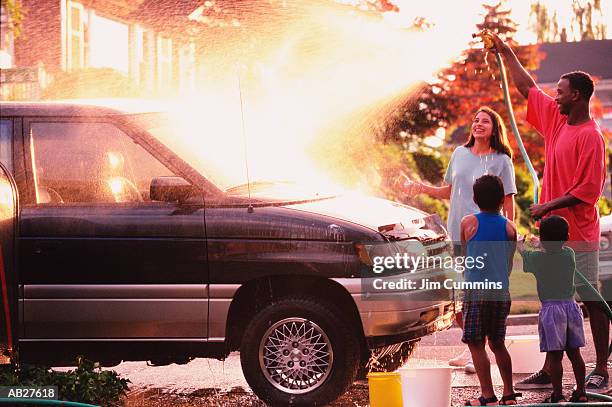 brothers (4-8) helping mother and father wash car - cummins stock pictures, royalty-free photos & images