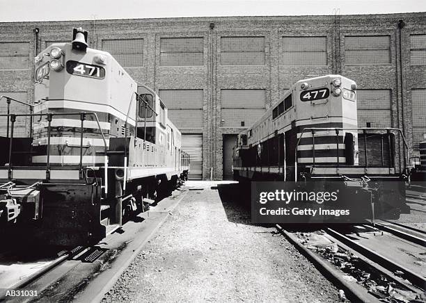 two trains in station (b&w) - cowcatcher stock-fotos und bilder