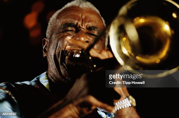 mature man playing trumpet, close up - trumpet fotografías e imágenes de stock