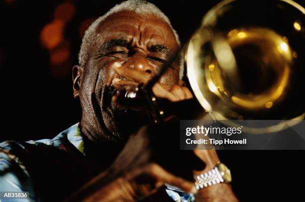 mature man playing trumpet, close up - trumpet stock pictures, royalty-free photos & images