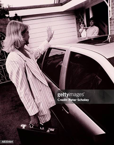businesswoman standing beside car, waving goodbye to family (b&w) - 07 stock pictures, royalty-free photos & images