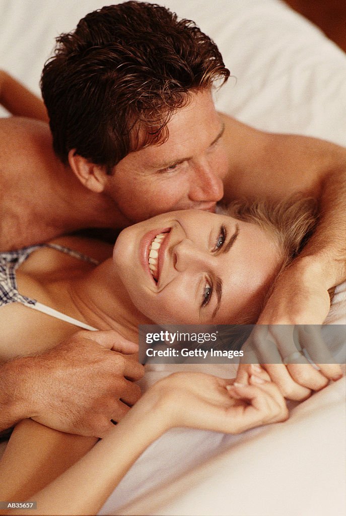 Couple lying on bed, close-up