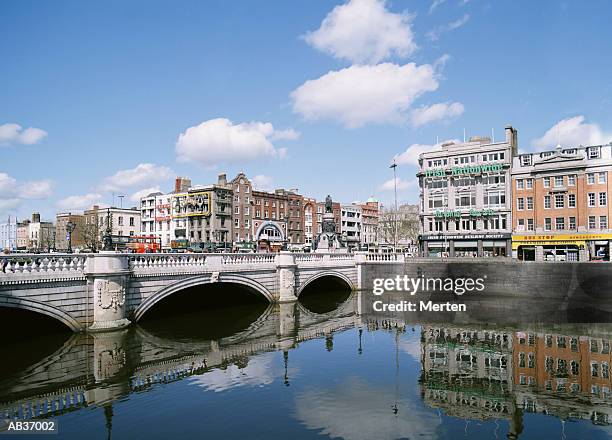 ireland, dublin, o'connell bridge over liffey river - liffey river ireland stock pictures, royalty-free photos & images