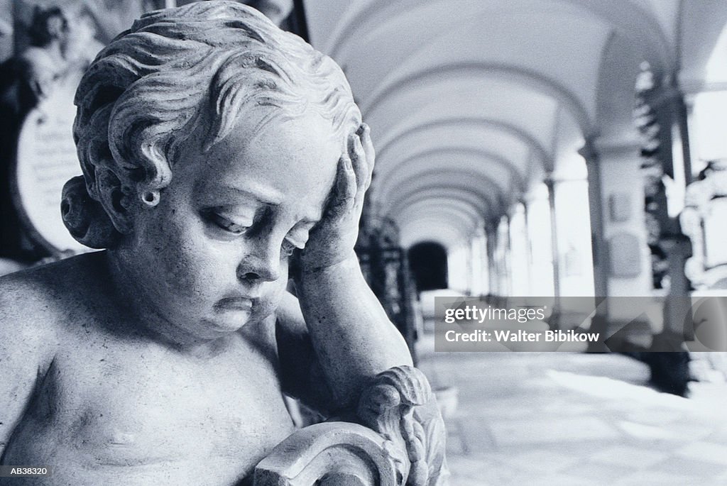 Statue of cherub in loggia, close-up (B&W)