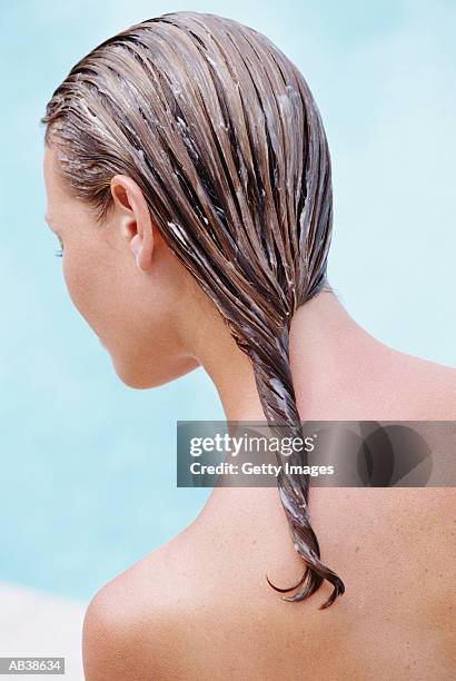 woman with conditioner in hair, rear view - shampoo photos et images de collection