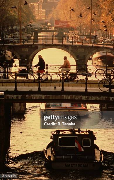 holland, amsterdam, canal and bridge traffic - tanaka stock pictures, royalty-free photos & images