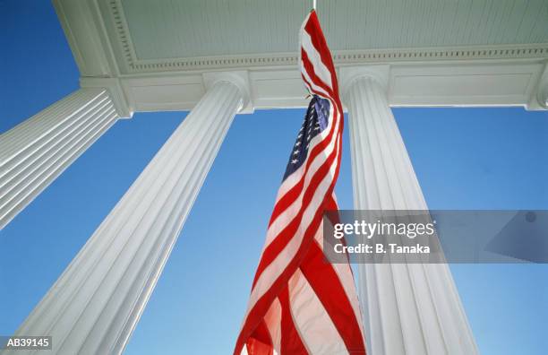 antebellum home and us flag, low angle view - antebellum stock pictures, royalty-free photos & images