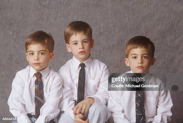 three brothers (4-9) wearing ties, sitting together, portrait - adult imitation stock pictures, royalty-free photos & images