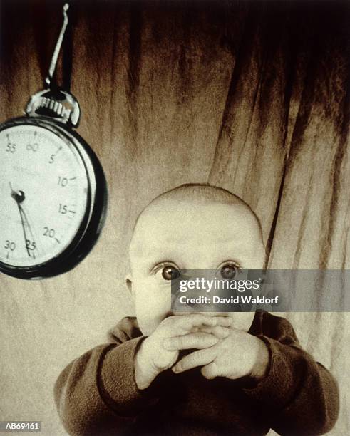 baby (6-9 months) and stopwatch (toned b&w) - waldorf fotografías e imágenes de stock