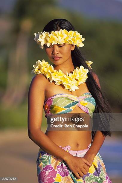 woman outside wearing floral haku - lei day hawaii stock-fotos und bilder