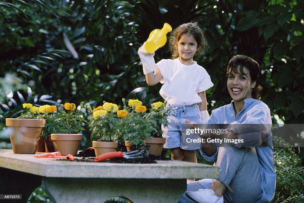 Mother and daughter (4-6) in garden, portrait