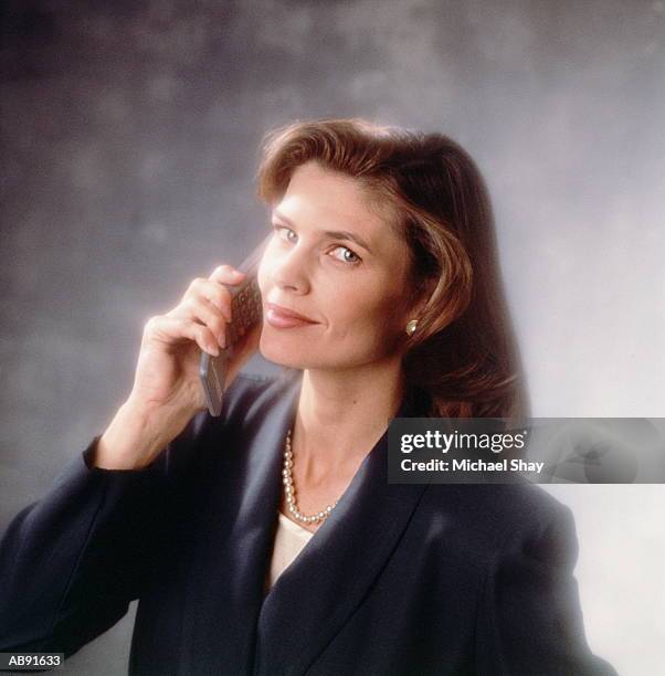 businesswoman holding mobile phone, portrait - 80s business women stock pictures, royalty-free photos & images