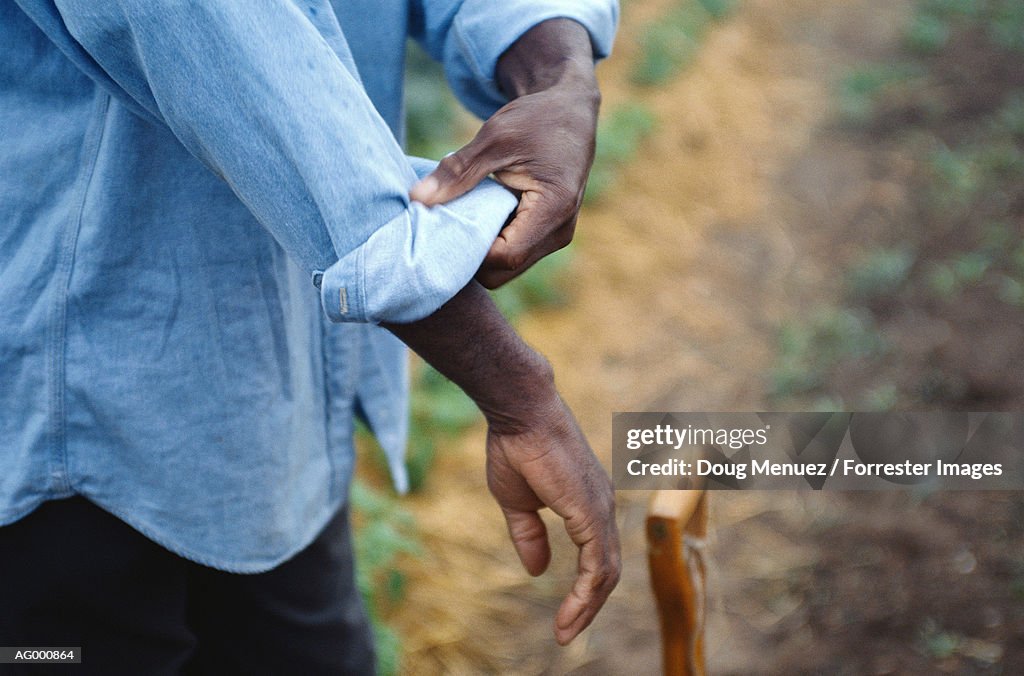 Man Rolling Up His Sleeves