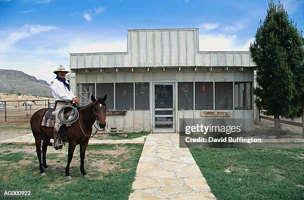 cowboy at the stables - werkdier stockfoto's en -beelden