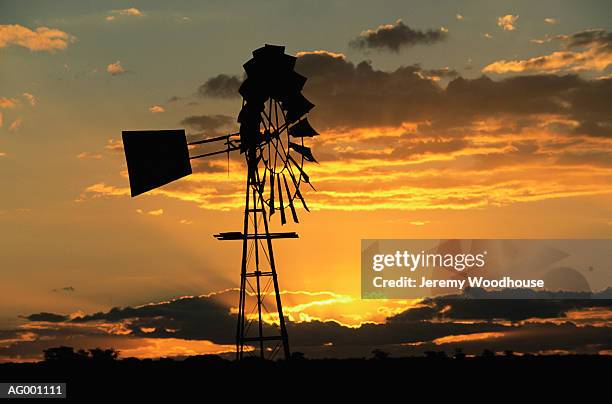 windmill at sunset - 工業用風車 ストックフォトと画像