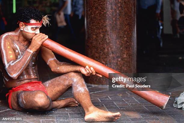 aboriginal man playing dijeradoo,sydney,australia - indigenous australians stock-fotos und bilder