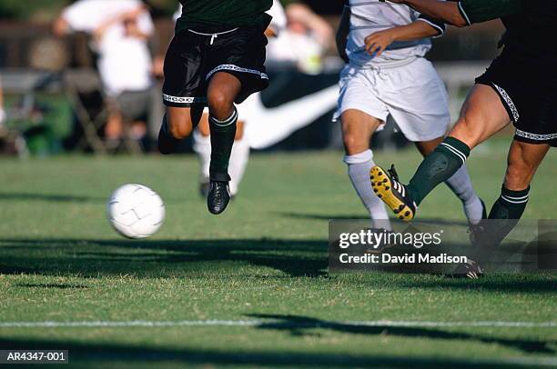 football players running for ball during game, close-up - tackle stockfoto's en -beelden