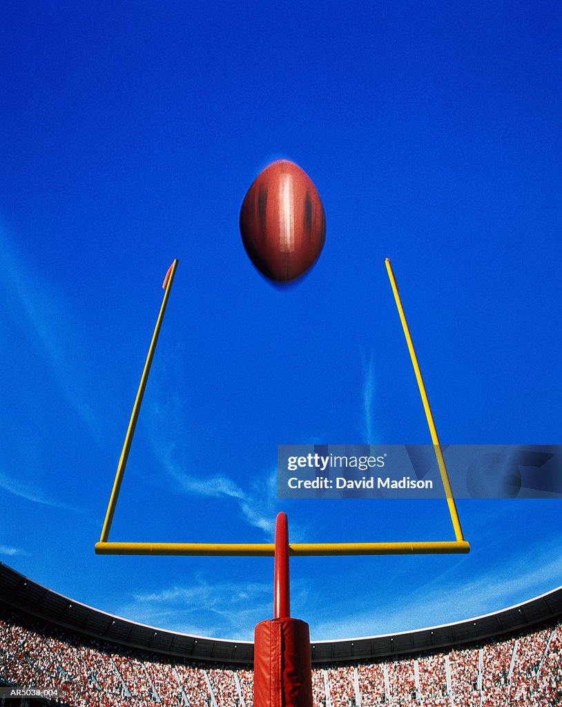 American football, ball flying over goal (Digital Composite)