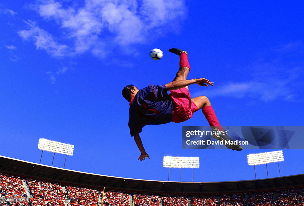 Soccer player 'bicycle kicking' ball (Digital Composite)
