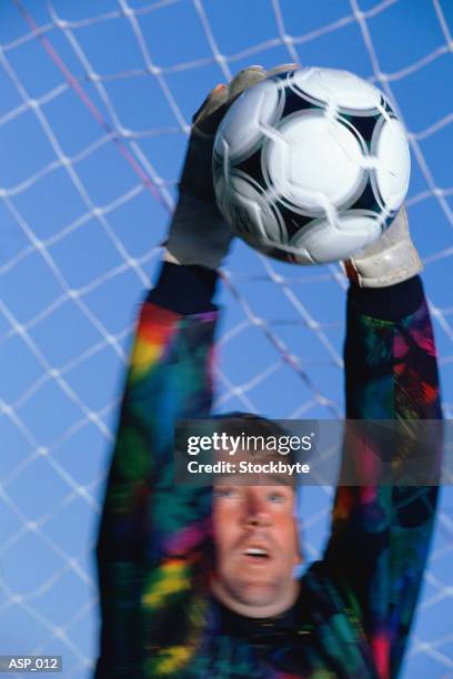goalie grabbing soccer ball - guantes de portero imágenes fotografías e imágenes de stock