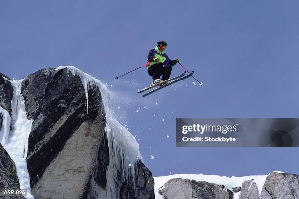 extreme downhill skier going off jump - precipice stock pictures, royalty-free photos & images