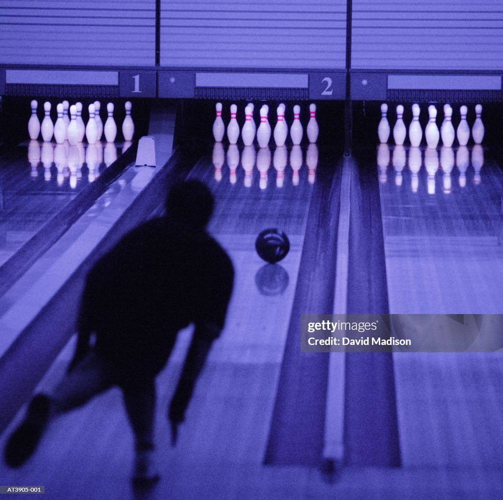 Man ten pin bowling, rear view (Digital Enhancement)