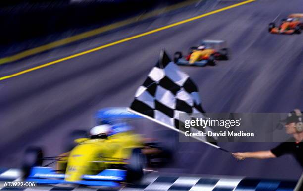 motor racing official waving chequered flag (digital composite) - autorennen stock-fotos und bilder