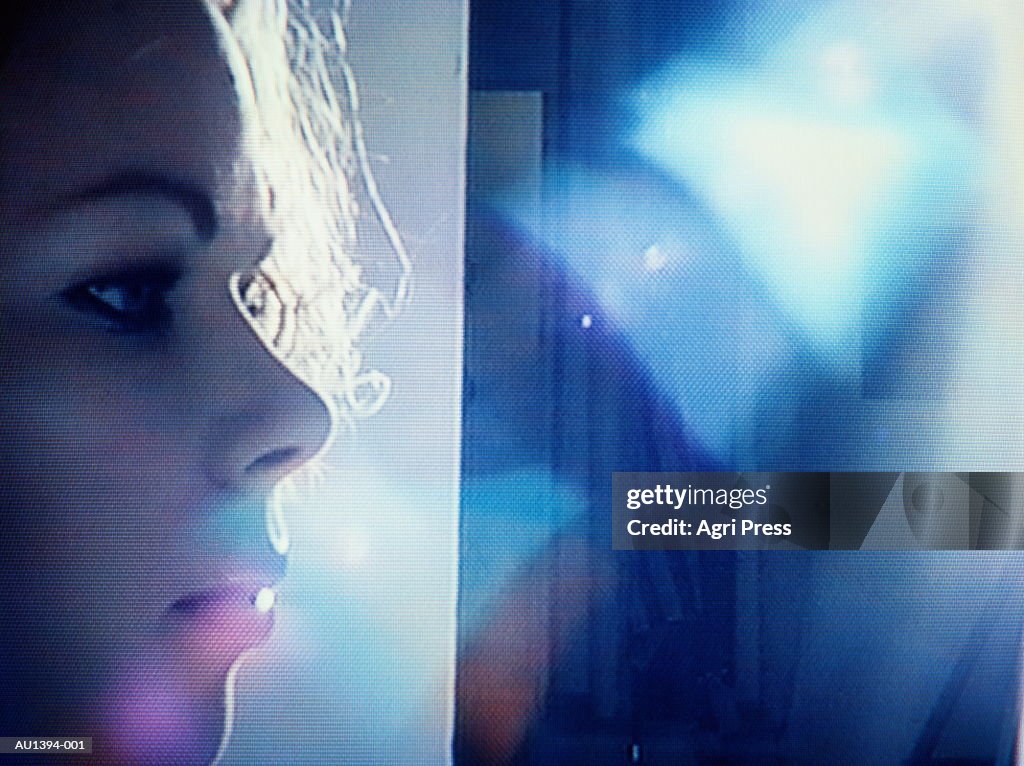 Young woman on studio set, profile, backlit (video still)