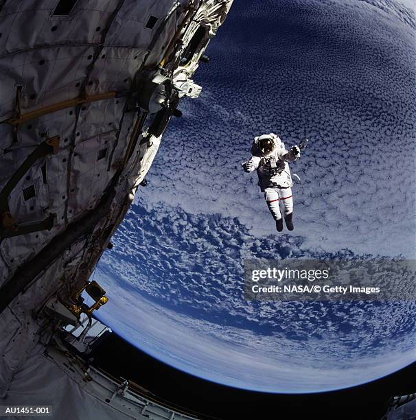astronaut floating near satellite, earth in background (enhancement) - astronaut bildbanksfoton och bilder