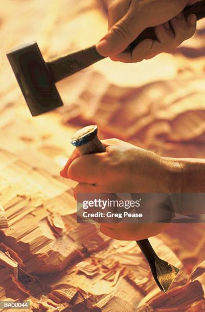 man using hammer and chisel to sculpt wood, close-up - greg pease stock pictures, royalty-free photos & images