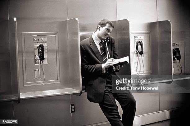 businessman using pay phone (b&w) - hopewell stock pictures, royalty-free photos & images