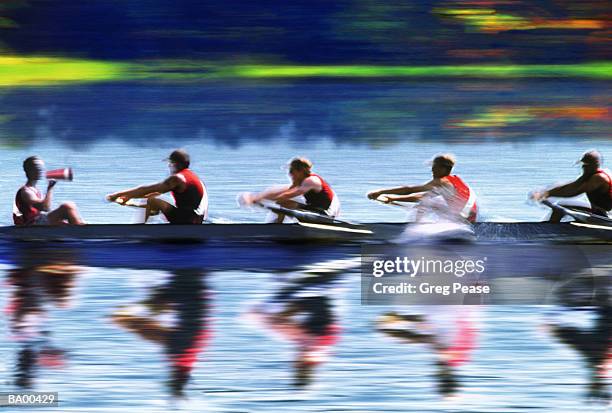 coxswain leading four man rowing crew (blurred motion) - coxed rowing stock pictures, royalty-free photos & images