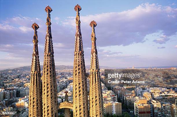 europe, spain, barcelona, spires of sagrada familia and skyline - familia stock pictures, royalty-free photos & images
